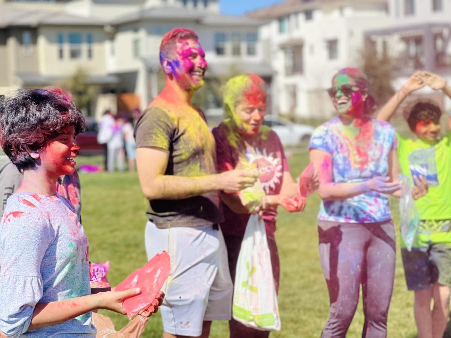 After throwing colors on one another, Holi event attendees find time to talk with friends and family in a day filled with laughter, smiles, and fun.