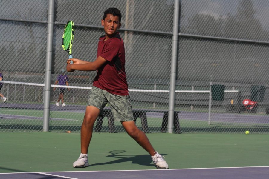 Aaron Sharma ('25) sets his position to be ready to catch a serve from the opponent.