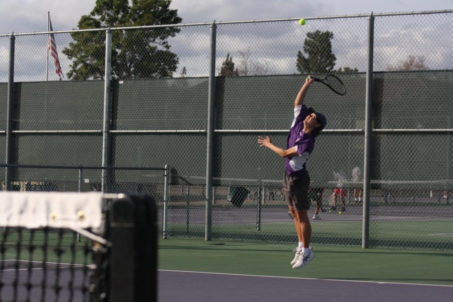 Bryan Park ('23) jumps high in the air to serve in his first round of the day.
