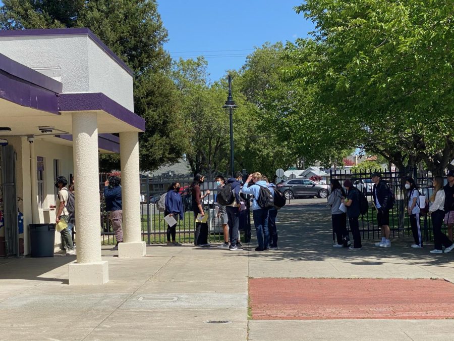 Seniors flock the activities window outside the office to turn in their senior ball packets.