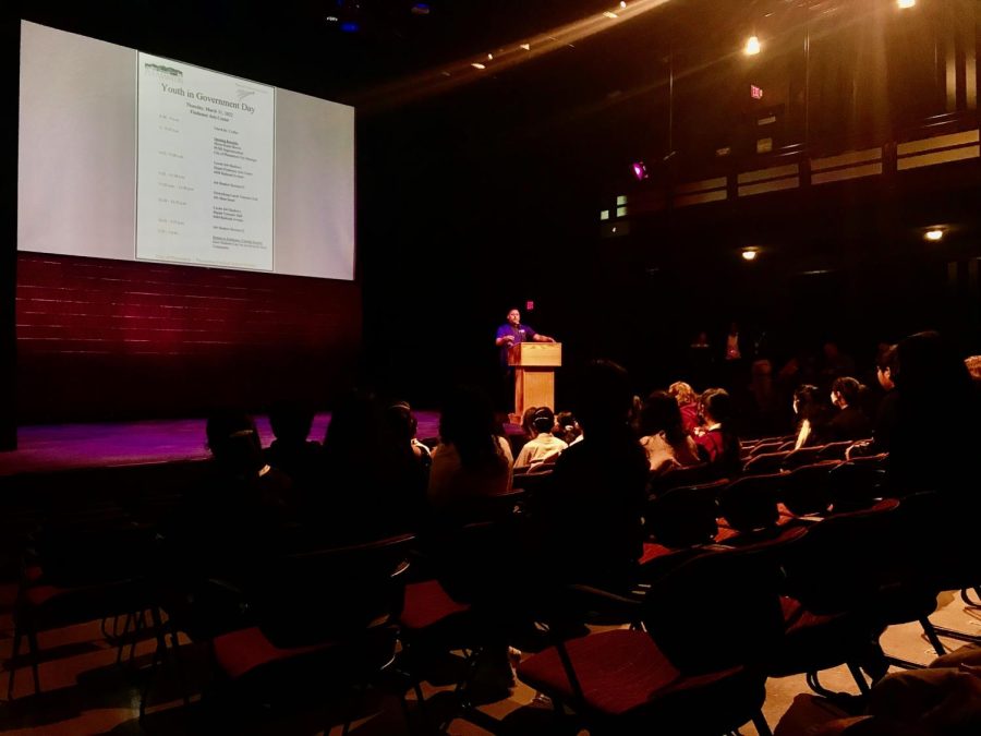 Presenting to the student attendees, Julian Mireles speaks in the Firehouse Theater explaining the schedule for the day.