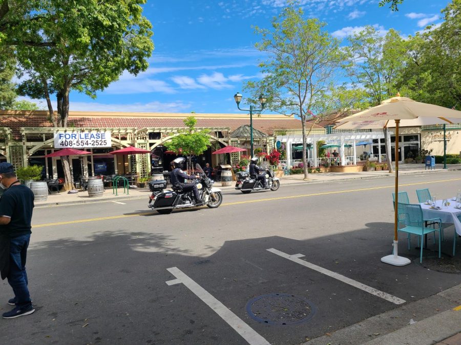 Police on motorcycles help with the process of removing cars and maintaining street closure.