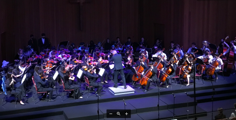 Aubel conducts Symphony Orchestra during his last concert. 