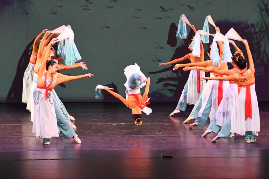 The dancer does a front aerial as everyone poses with their silk fans. (Jiawen (Sarah) Yan)