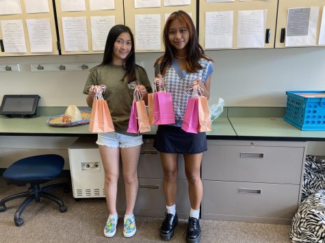 Sarah Yang (23) and MIlla Zuniga (23) pose with completed goodie bags.