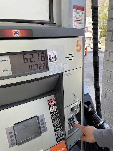  An AVHS parent fills their vehicle with gasoline, noting the price and the amount.