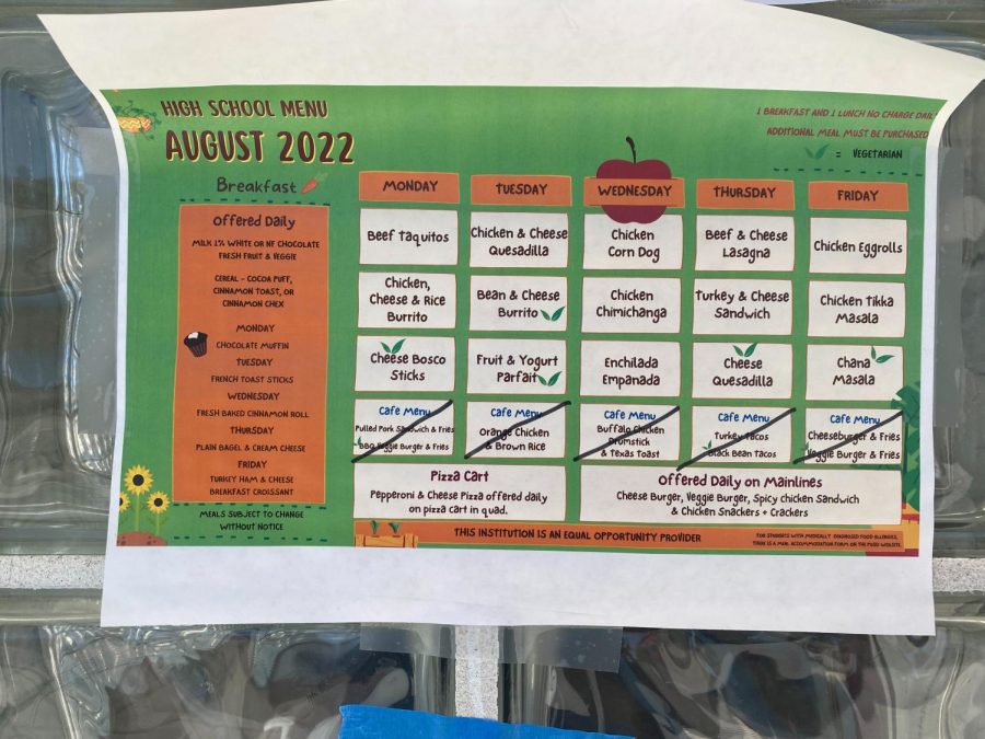 The August school menu includes both breakfast and lunch, and lists the daily meal options that marks specific dishes as vegetarian.