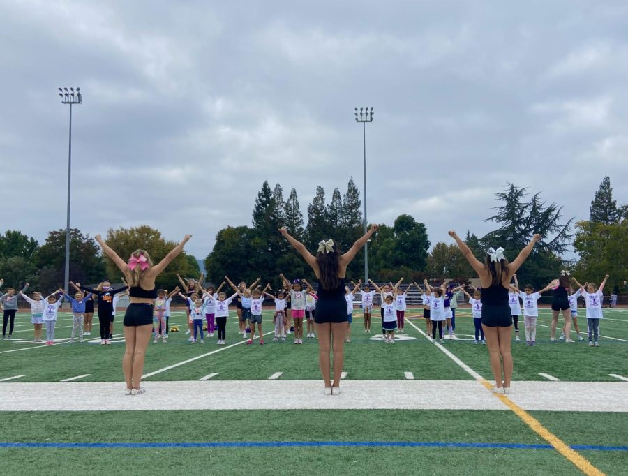 The AV Cheer Team stands in a High V as the students follow closely.