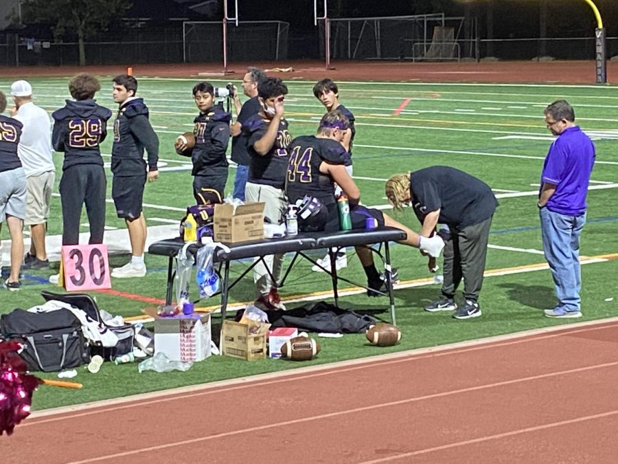 Amador Athletic Trainer Diana Hasenpflug treats a players injury during a game against Clayton Valley.