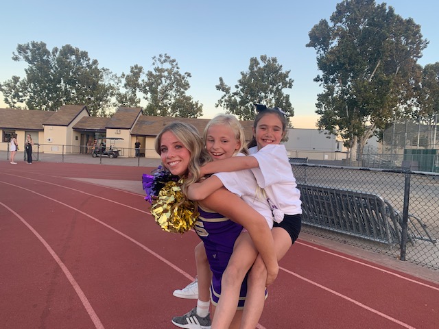 Aspiring cheerleaders perform at freshman football game