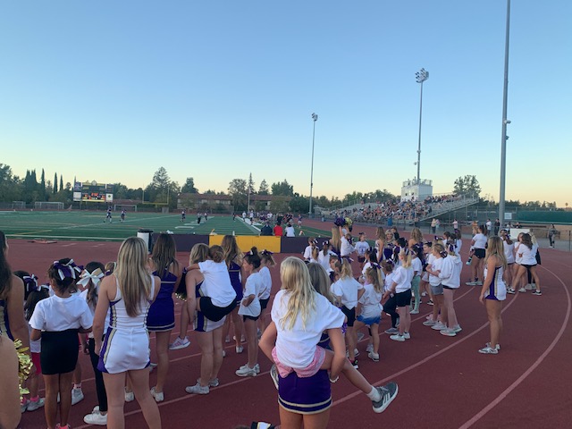 Aspiring cheerleaders perform at freshman football game