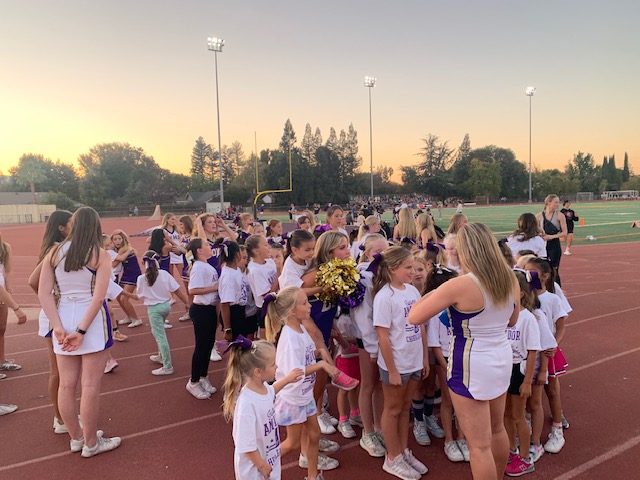 Aspiring cheerleaders perform at freshman football game
