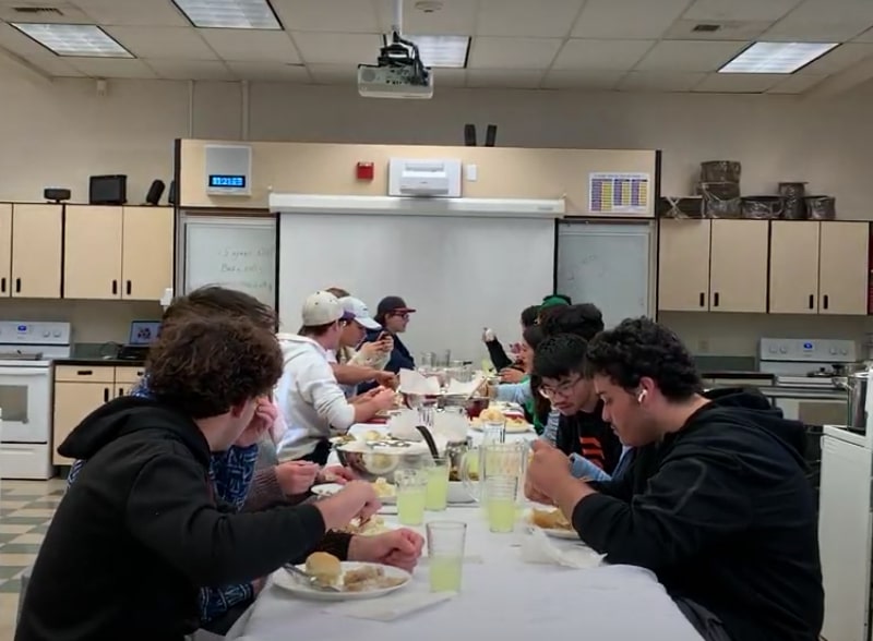 After their hard work, the classes are able to gather together and eat their Thanksgiving meal.