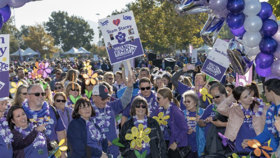 Team Stacy from the 2021 East Bay Walk to End Alzheimer’s is seen at the walk with their T-shirts and signs, among balloons and many other crowds. This year's event aims to raise more funds to help in disease research.
