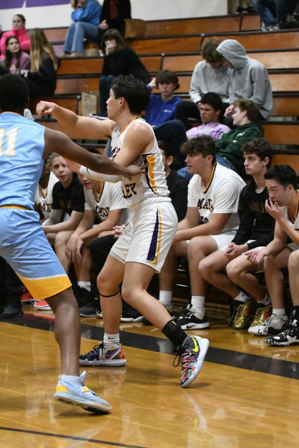 Jesse Huang (23) directs his teammates across the court.