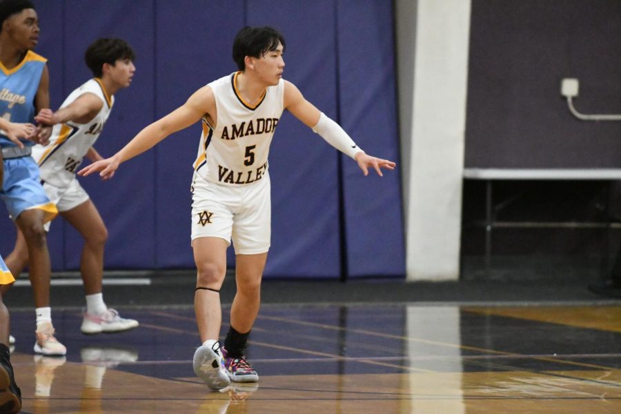 Jesse Huang (23) guards his space on the court.
