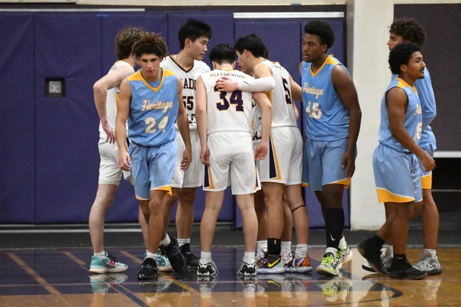 The boys huddle together strategizing their next plays. 