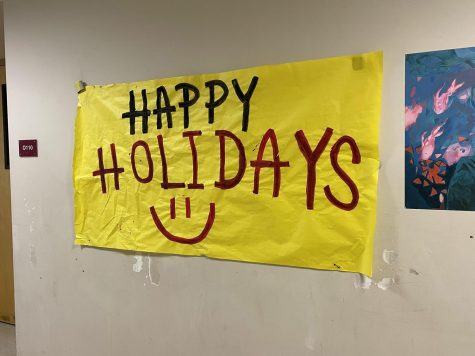 Holiday themed posters are set up in the Q building hallway.
