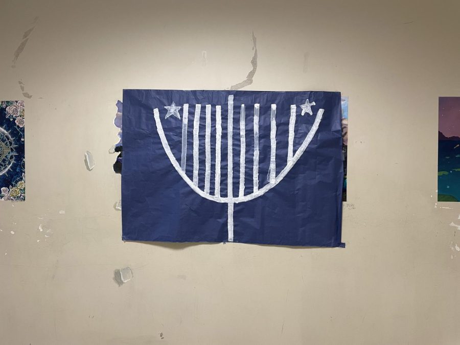 Leadership decorates the Q building halls with Hanukkah posters.
