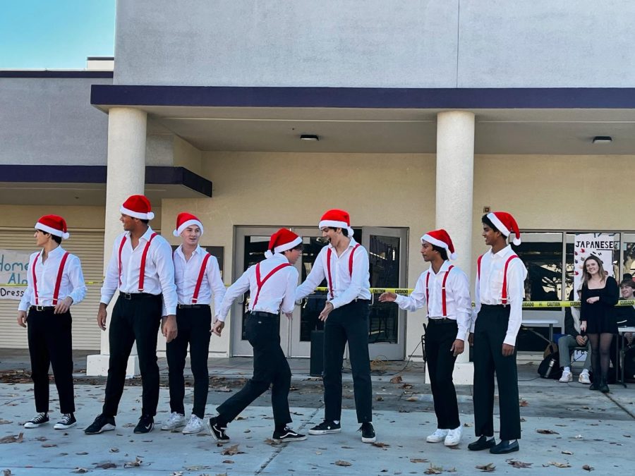 As the list of introduction wrapped up, the contestants lined up for a high-five chain for the last few boys. They all donned red Santa hats with matching suspenders to get into the holiday spirit. 