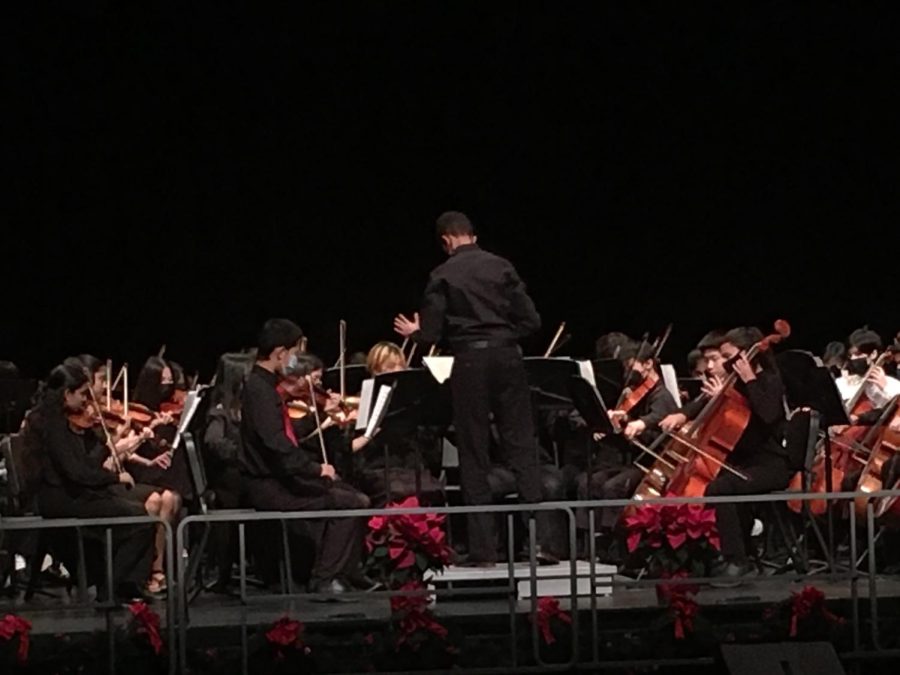 Haben Naizghin (26’) conducts the String Orchestra while they play “Spirited Away.”