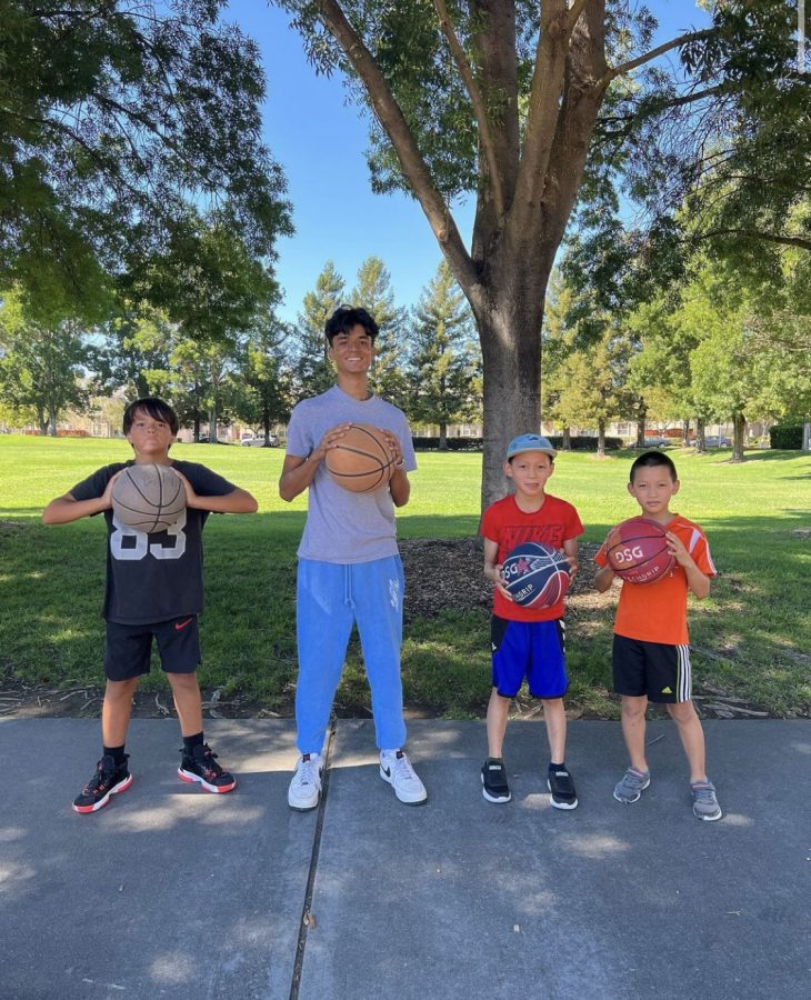 Darsh Shah (24) gets ready to teach some basketball skills to young players in Young Champions Academy. 