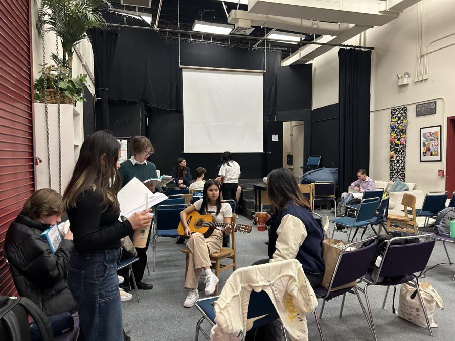 Cast members warm up backstage before their rehearsal.
