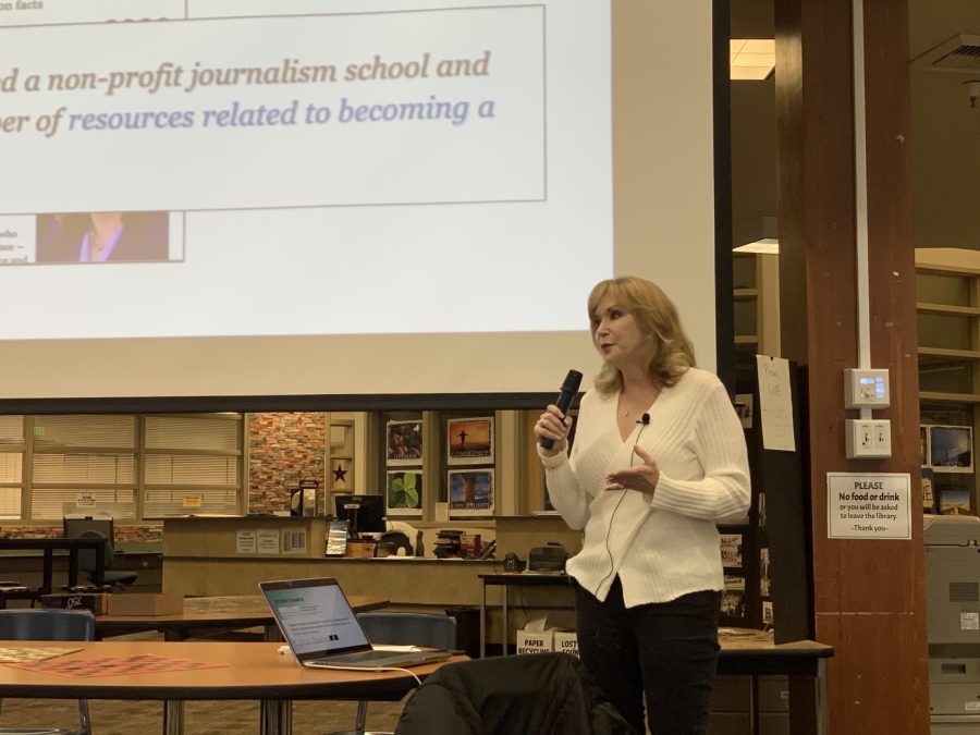 Gina Wilcox tells stories about her journalism career during her presentation.