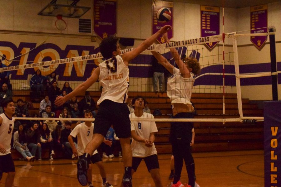 Nate Clinton pushes the ball above the defenders to score a point.
