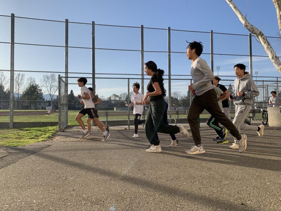 Track runners going for a warm-up lap before starting practice.