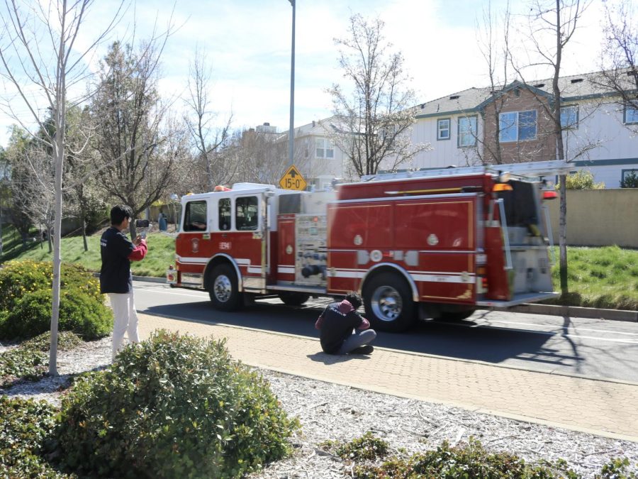 Video production crew Srikar Pasala ('24) and Amit Krishna ('24) film a firetruck arriving on the scene.