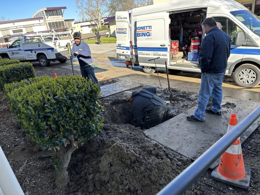 Workers exploring the sinkhole which was an indicator of bigger problems with the water line to Amador Valley. The sinkhole was caused by a broken pipe underground between the B building and A building.
