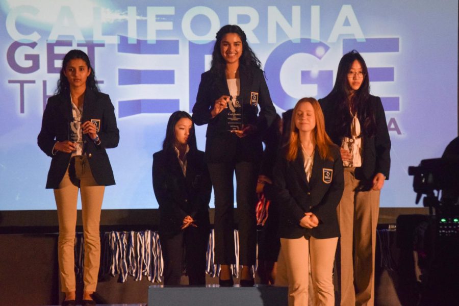 Samaira Mehta (‘24) smiles atop the podium after placing first in the Apparel and Accessories Marketing series.
