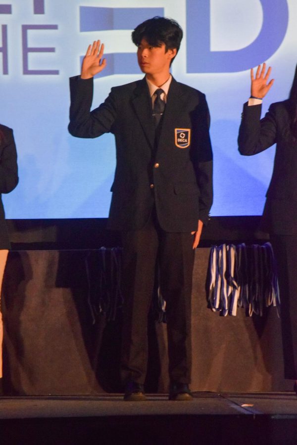 Leo Shao (‘24) raises his hand as he is sworn in as the California DECA President for 2023-24.
