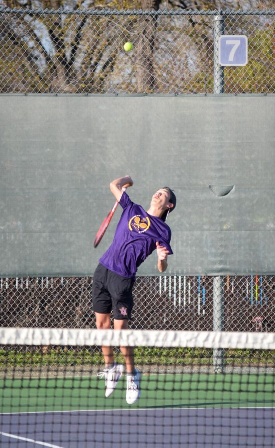 Aidan Doan (‘24), jumps to hit a serve in his doubles three matchup.
