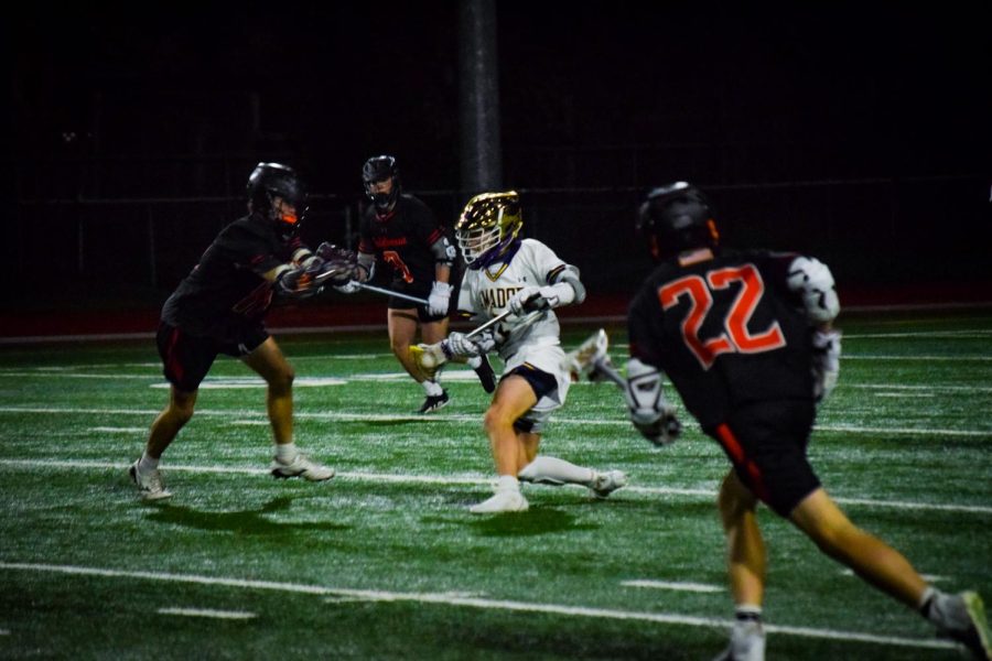 #5 Brady Macisaac ('25) weaves through defenders with the ball.
