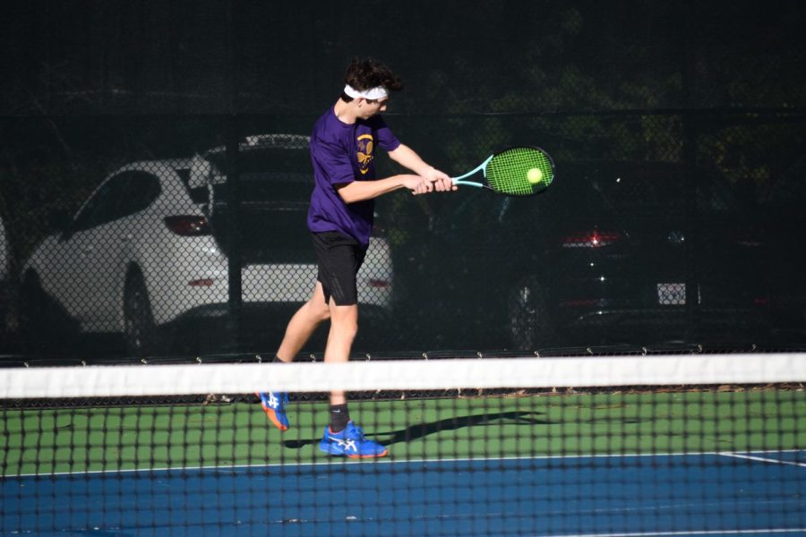 Nigel Purvis (‘24) focuses as he strikes a backhand from the baseline.
