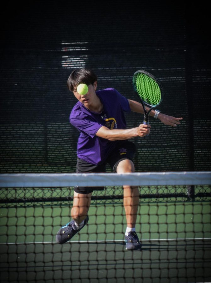 Minsung Kim (‘25), playing two singles, watches intently as he slices a forehand to his opponent.
