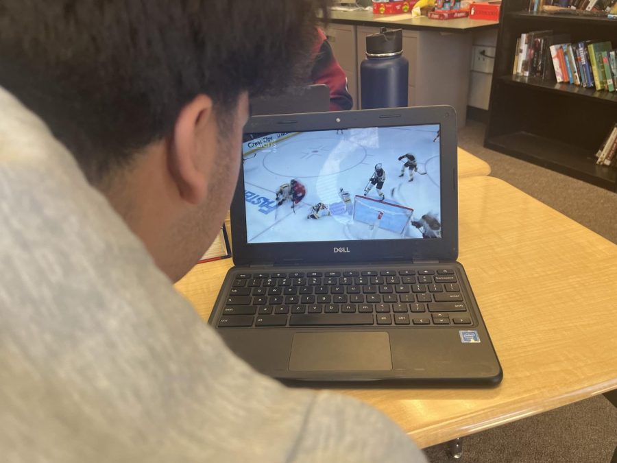 A student watches the Bruins game as they try to defeat the Panthers in round one of the playoffs.