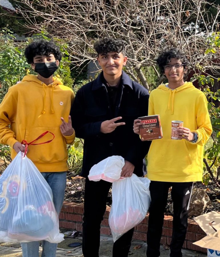 Ishan Junnarkar (24), pictured in center, poses with members of Magnus after collecting donations for the non-profit.