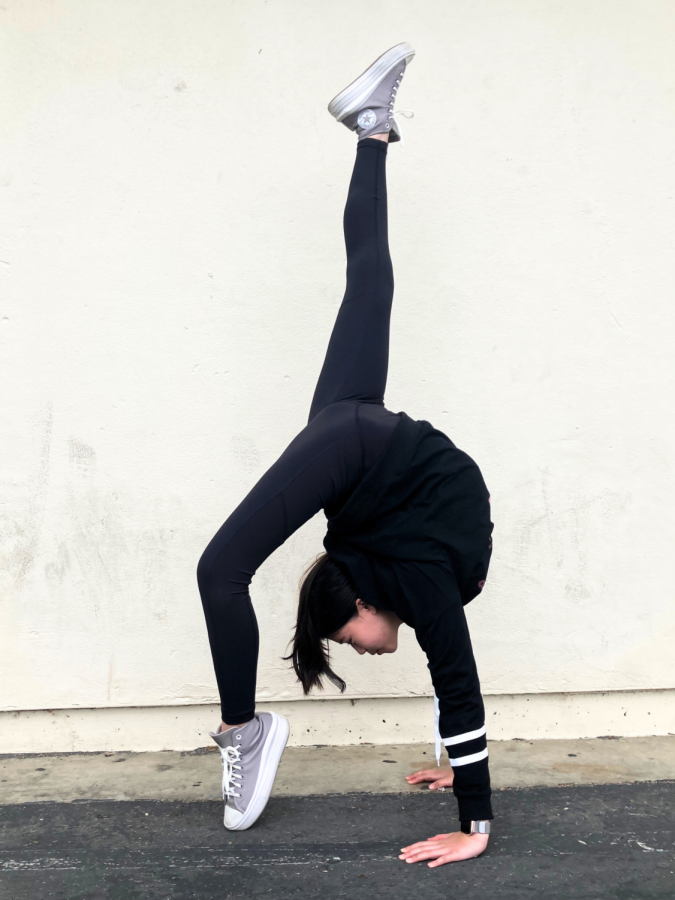 Kiera Lai (24) holds a bridge while kicking her leg up, a popular pose in contortion.