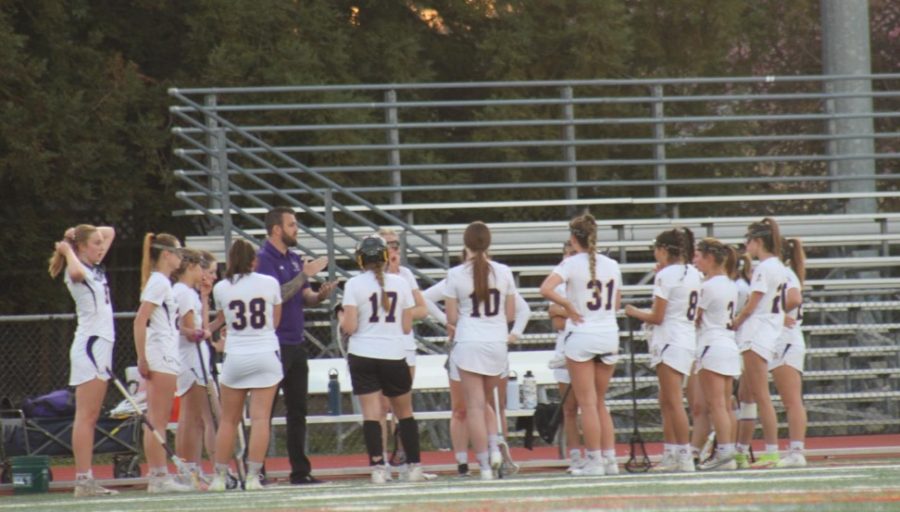 Coach Kyle Riddle talks to the team during a timeout.