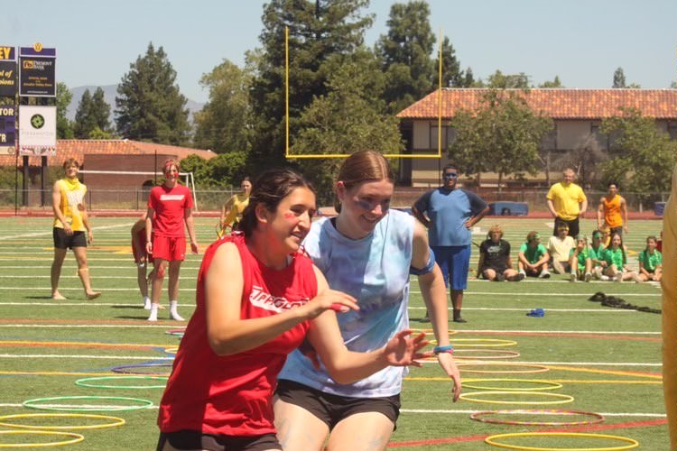 Sydney Head (‘24) and Charlotte Kelly (‘25) go through the hula hoop obstacle course in the Survivor Rally.