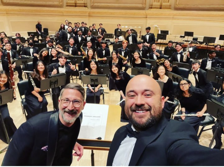 Band directors Jonathan Grantham and Edwin Cordoba take a selfie with the two wind ensembles during their morning soundcheck before their performance. (Photo provided by Amador Valley Bands.) 
