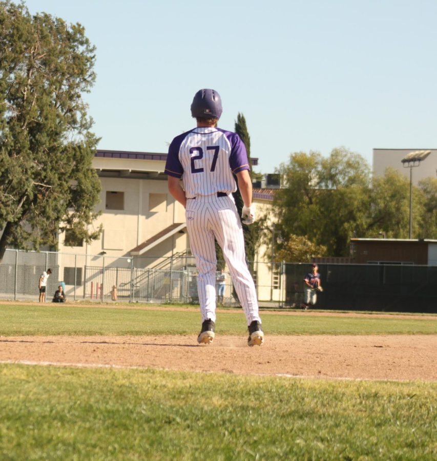 Mitchell Krieder (23) rounds the bag and stares at the ball he struck into left field.