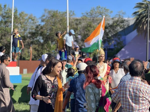 Amidst an exhilarating atmosphere of national pride, attendees joyfully participate in a spirited flag parade, waving the Indian tricolor high, accompanied by the stirring melodies of Indian nationalism echoing in the background.