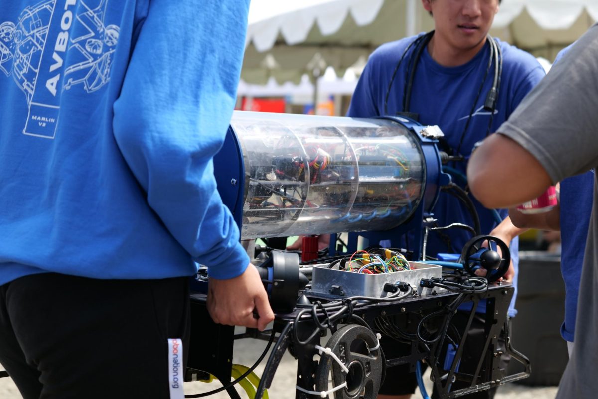 Certain members of the AvBotz team carefully transport their sub to a work station during the competition. 