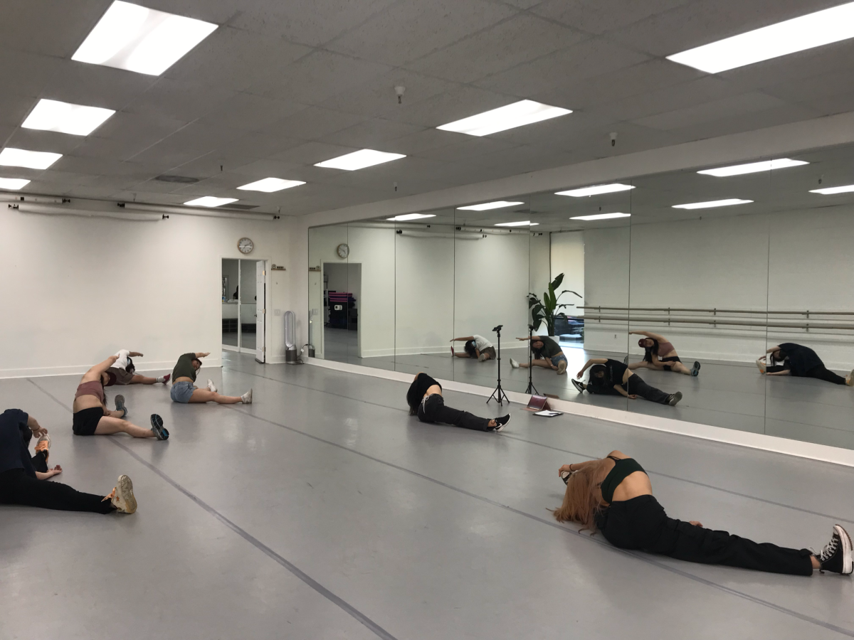 Zhou starts every class with warm-up exercises and stretches before teaching the new eight-counts of dance.