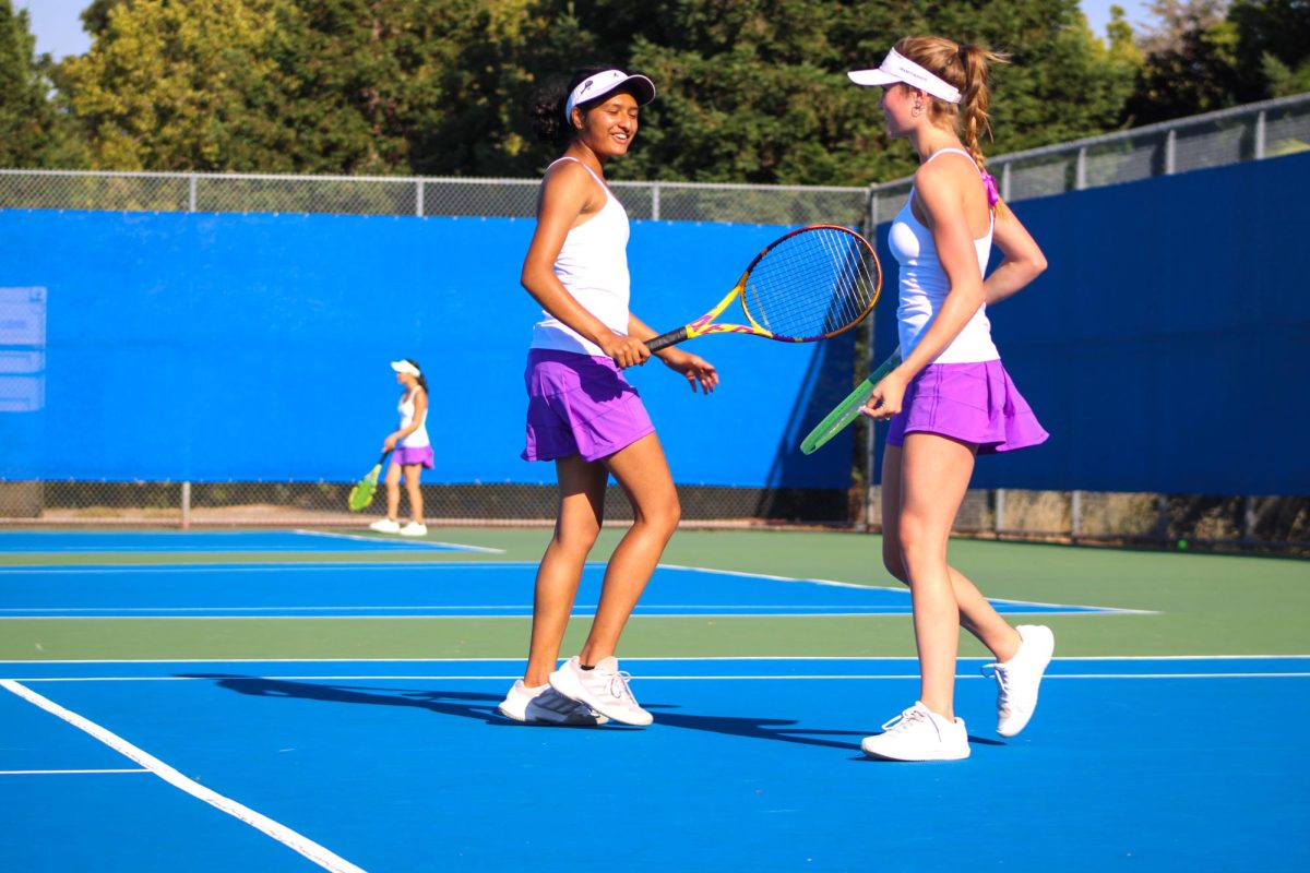 Aditi Deshpande (25) and Alayna West (25) celebrate a great play.