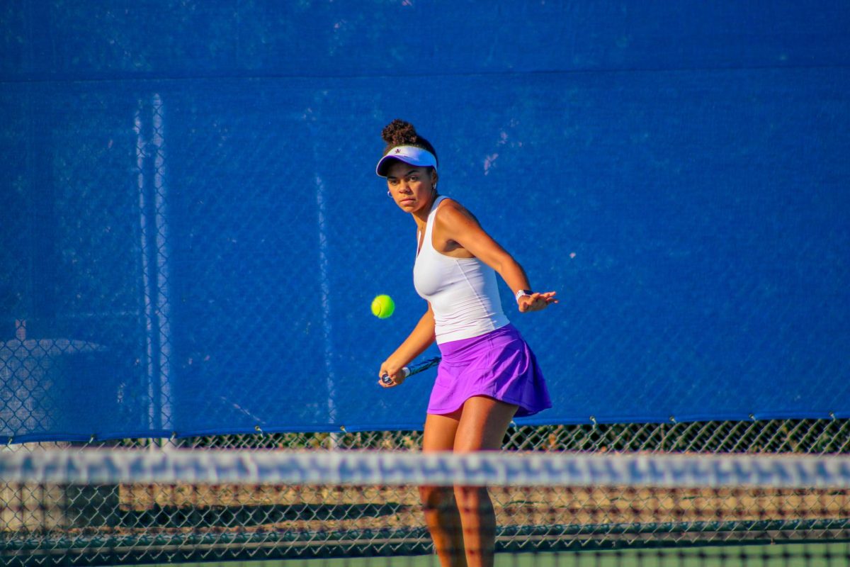 Returning a serve, Montana Parkinson-Lubold (24) watches the ball with Falcon-like precision.